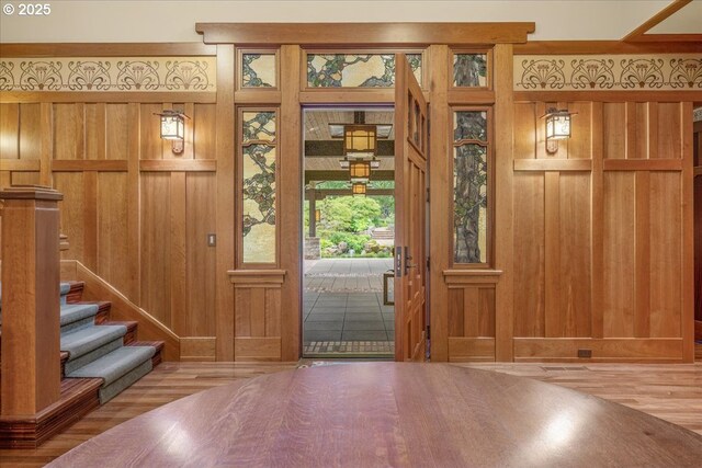 13150 SW Iron Mountain Blvd, Portland, OR 97219 - foyer featuring wood finished floors, wooden walls, and stairway