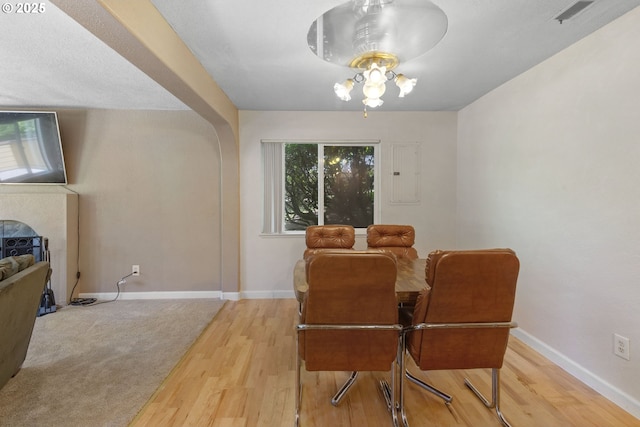 1621 NE 113th St Unit 132, Vancouver, WA 98686 - dining room with wood finished floors, baseboards, electric panel, and a fireplace