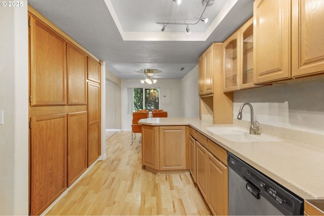 1621 NE 113th St Unit 132, Vancouver, WA 98686 - kitchen with dishwasher, a sink, light wood-style floors, a peninsula, and a tray ceiling