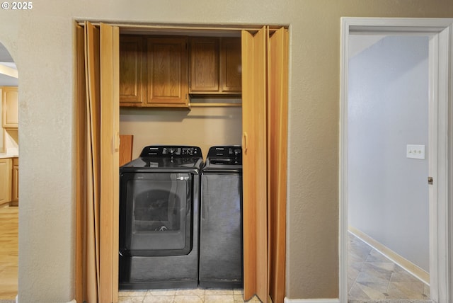 1621 NE 113th St Unit 132, Vancouver, WA 98686 - laundry room featuring arched walkways, independent washer and dryer, and cabinet space