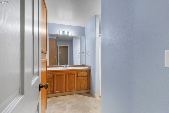 1621 NE 113th St Unit 132, Vancouver, WA 98686 - bathroom featuring vanity, baseboards, tile patterned floors, and a textured wall
