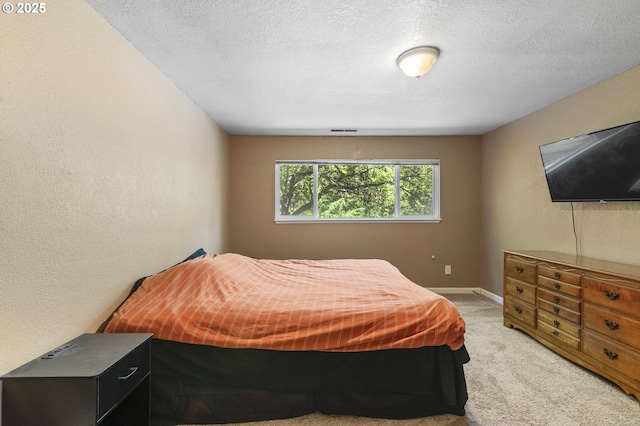 1621 NE 113th St Unit 132, Vancouver, WA 98686 - bedroom with light carpet, a textured ceiling, baseboards, and a textured wall
