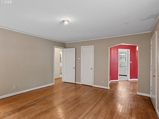 4315 SE 28th Pl, Portland, OR 97202 - unfurnished bedroom featuring wood-type flooring, a textured ceiling, crown molding, and baseboards