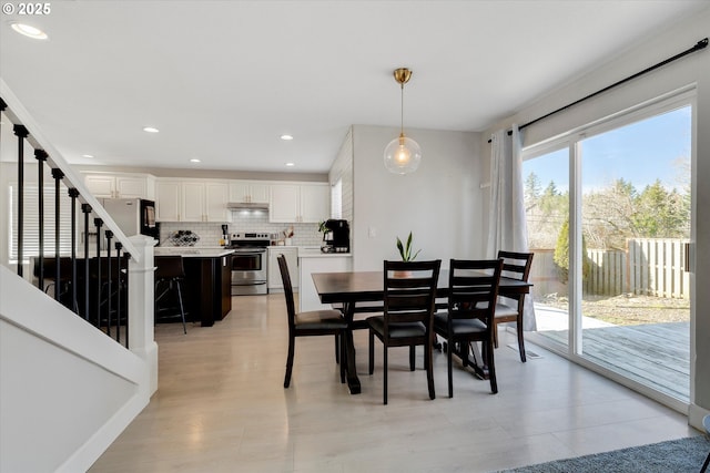 dining area with recessed lighting and stairs