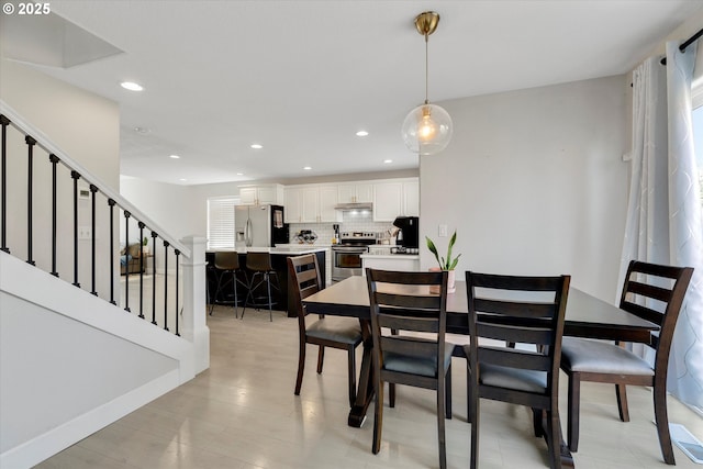 dining space featuring baseboards, stairway, and recessed lighting