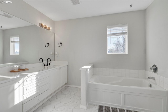 full bathroom with a garden tub, double vanity, a sink, and visible vents