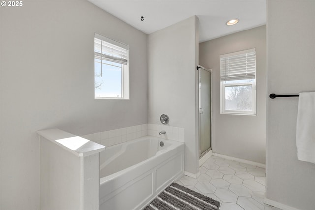 bathroom with a stall shower, a wealth of natural light, tile patterned flooring, and a bath