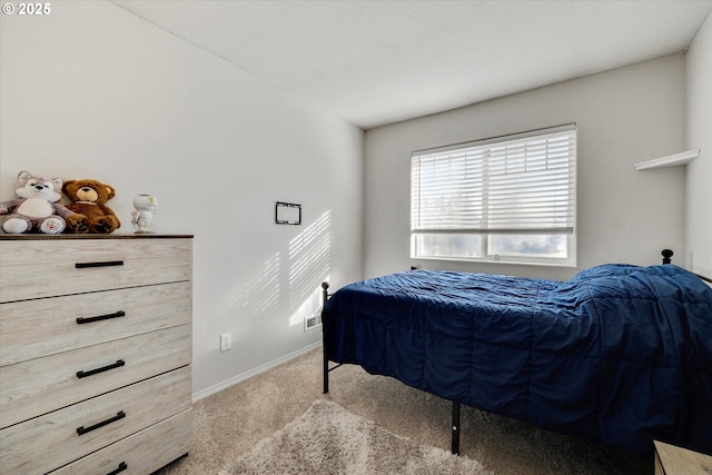 carpeted bedroom featuring baseboards