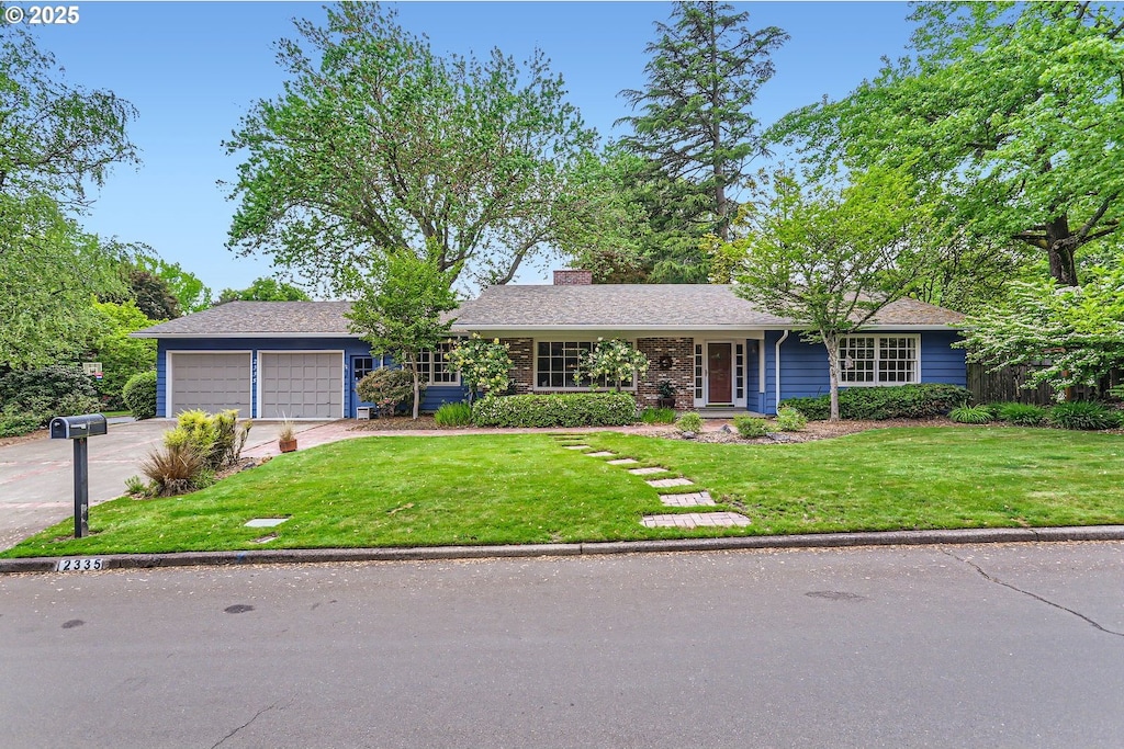 2335 SW Garden View Ave, Portland, OR 97225 - single story home with an attached garage, concrete driveway, a chimney, and a front yard