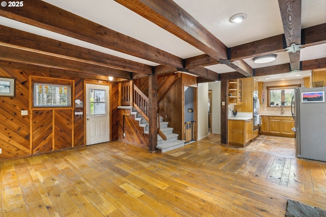 28272 S Hult Rd, Beavercreek, OR 97004 - kitchen with stainless steel appliances, light wood-type flooring, light countertops, beam ceiling, and wood walls