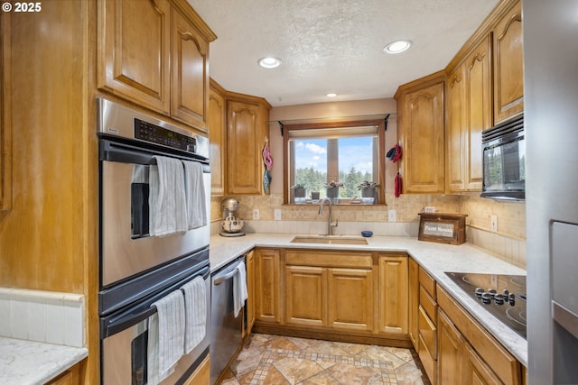 28272 S Hult Rd, Beavercreek, OR 97004 - kitchen featuring black appliances, a sink, brown cabinetry, recessed lighting, and a textured ceiling