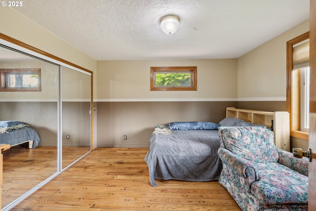28272 S Hult Rd, Beavercreek, OR 97004 - bedroom with wood finished floors, a textured ceiling, a closet, and baseboards