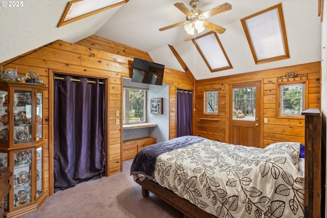 28272 S Hult Rd, Beavercreek, OR 97004 - bedroom featuring wood walls, vaulted ceiling, multiple windows, carpet floors, and a skylight