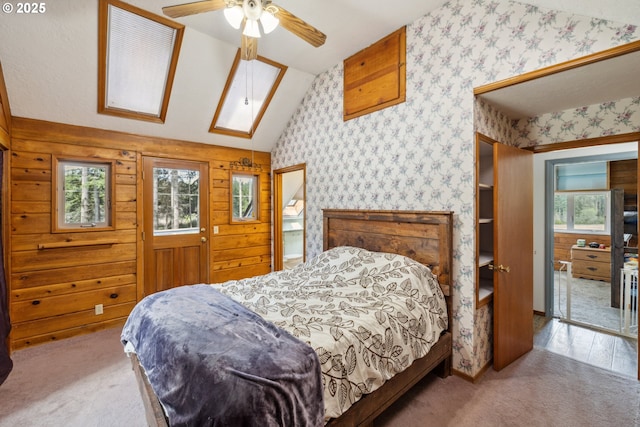 28272 S Hult Rd, Beavercreek, OR 97004 - bedroom with lofted ceiling, carpet floors, wallpapered walls, a skylight, and ceiling fan
