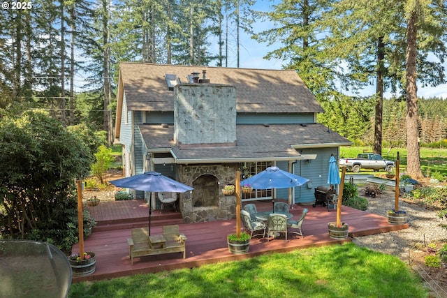 28272 S Hult Rd, Beavercreek, OR 97004 - back of house with outdoor dining area, a chimney, a wooden deck, a shingled roof, and stone siding