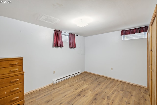 28272 S Hult Rd, Beavercreek, OR 97004 - unfurnished bedroom with baseboard heating, light wood finished floors, and baseboards