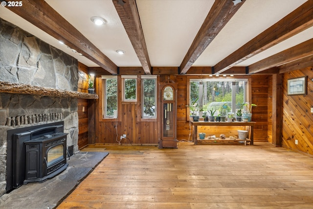 28272 S Hult Rd, Beavercreek, OR 97004 - unfurnished living room featuring wooden walls, hardwood / wood-style floors, a wood stove, and beamed ceiling