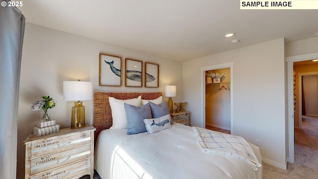 bedroom featuring a walk in closet and carpet floors