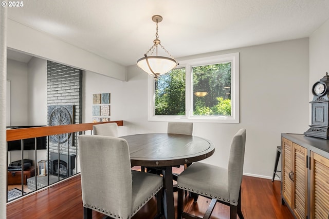dining room featuring baseboards and dark wood-type flooring