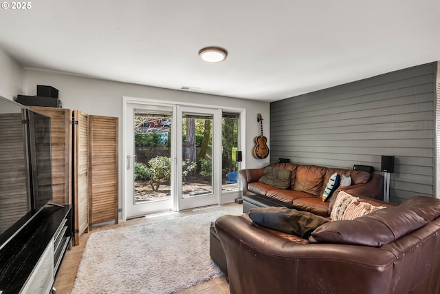 living room with wooden walls and visible vents