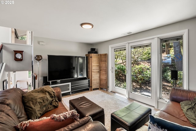 living area with visible vents and light tile patterned flooring
