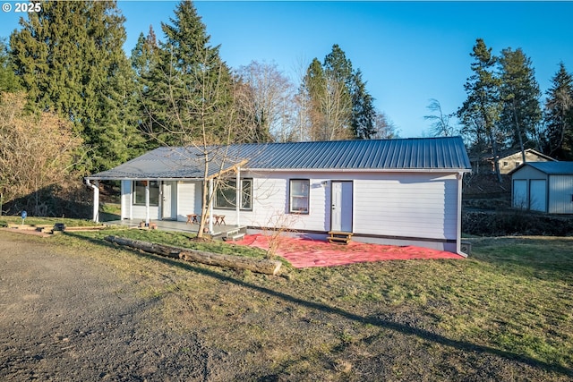1502 Columbia St, Cathlamet, WA 98612 - single story home with an outdoor structure, a storage shed, a front yard, a patio, and metal roof