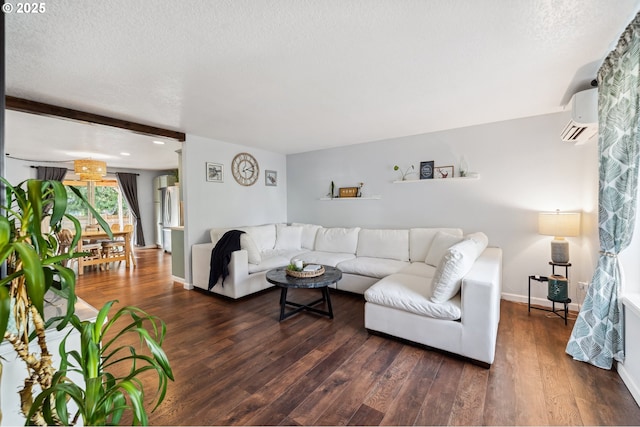 living area with a textured ceiling, a wall mounted air conditioner, dark wood finished floors, and baseboards