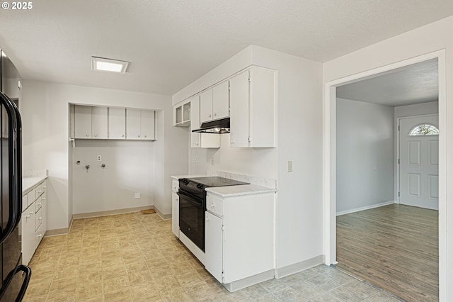 881 S Linden St, Cornelius, OR 97113 - kitchen featuring black appliances, under cabinet range hood, white cabinets, light countertops, and a textured ceiling