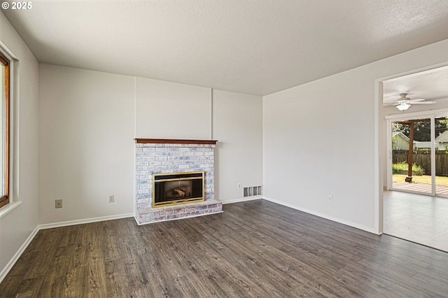 881 S Linden St, Cornelius, OR 97113 - unfurnished living room featuring dark wood-type flooring, a brick fireplace, and a ceiling fan