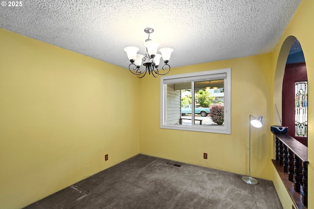 233 SE Paloma Ave, Gresham, OR 97080 - unfurnished dining area with arched walkways, dark colored carpet, plenty of natural light, a chandelier, and a textured ceiling