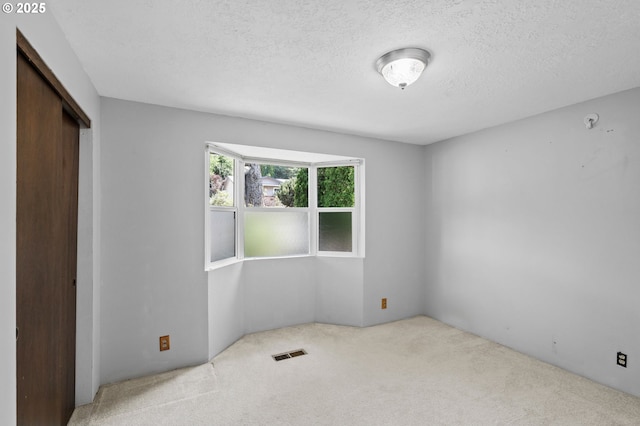 233 SE Paloma Ave, Gresham, OR 97080 - unfurnished bedroom with carpet floors, a closet, and a textured ceiling