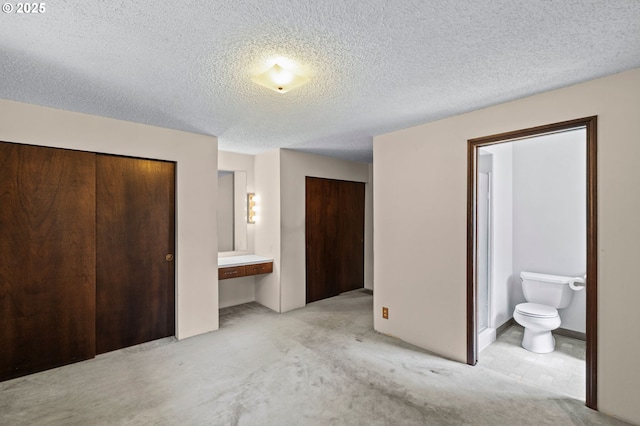 233 SE Paloma Ave, Gresham, OR 97080 - unfurnished bedroom featuring two closets, light colored carpet, ensuite bath, and a textured ceiling