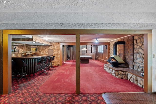 233 SE Paloma Ave, Gresham, OR 97080 - rec room with bar, a wood stove, a textured ceiling, and wooden walls