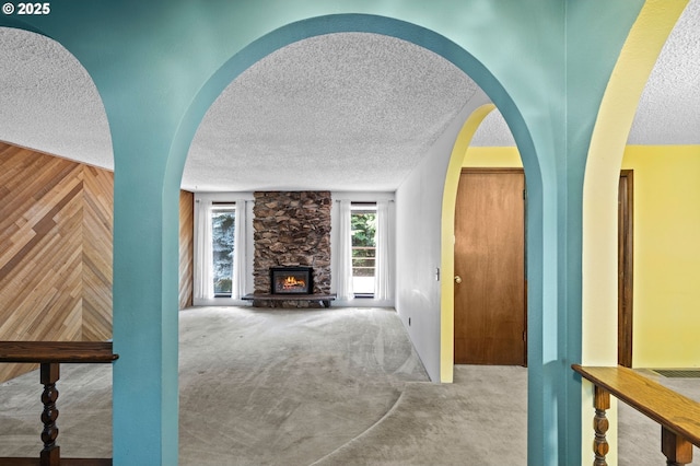 233 SE Paloma Ave, Gresham, OR 97080 - hallway with a textured ceiling, carpet flooring, arched walkways, and wood walls