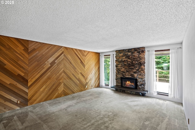 233 SE Paloma Ave, Gresham, OR 97080 - unfurnished living room featuring carpet floors, a textured ceiling, and a fireplace