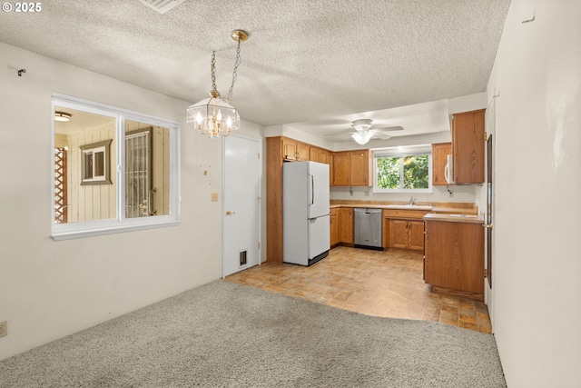 713 Brookside Cir, Rogue River, OR 97537 - kitchen featuring white appliances, brown cabinets, light countertops, ceiling fan, and a textured ceiling