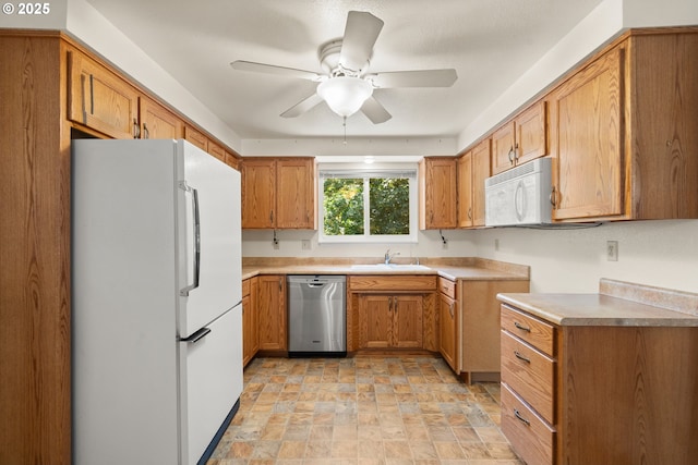 713 Brookside Cir, Rogue River, OR 97537 - kitchen featuring white appliances, ceiling fan, stone finish floors, and brown cabinetry