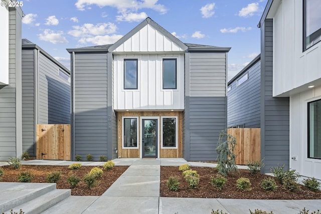 view of front facade featuring board and batten siding and fence