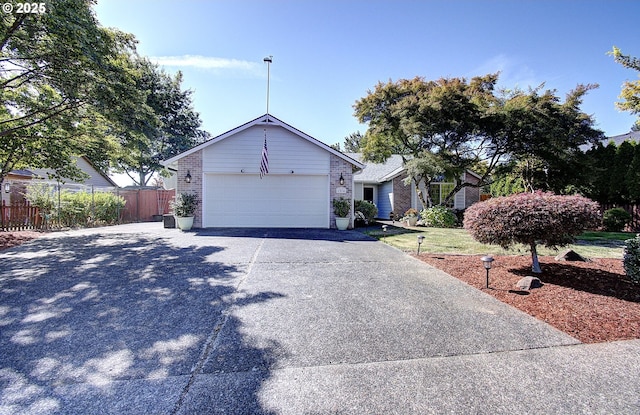 ranch-style home featuring concrete driveway, brick siding, an attached garage, and fence