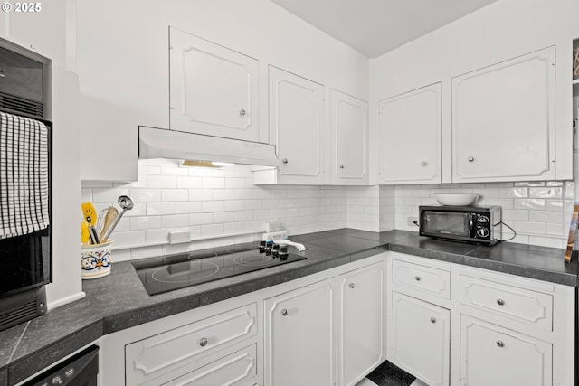 kitchen with white cabinets, backsplash, and black appliances