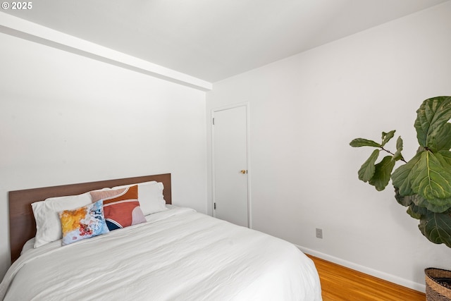 bedroom with hardwood / wood-style floors