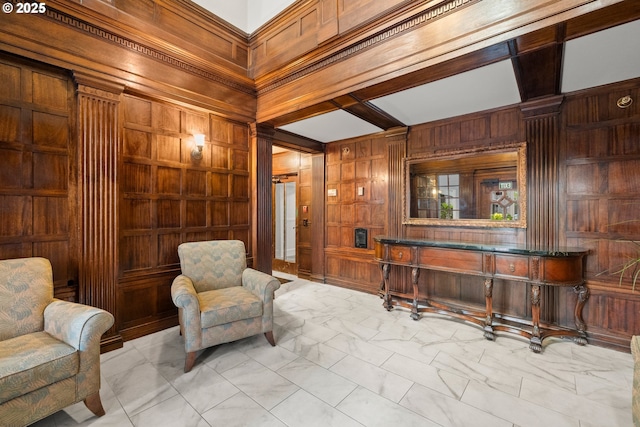 sitting room featuring beam ceiling, coffered ceiling, and wood walls