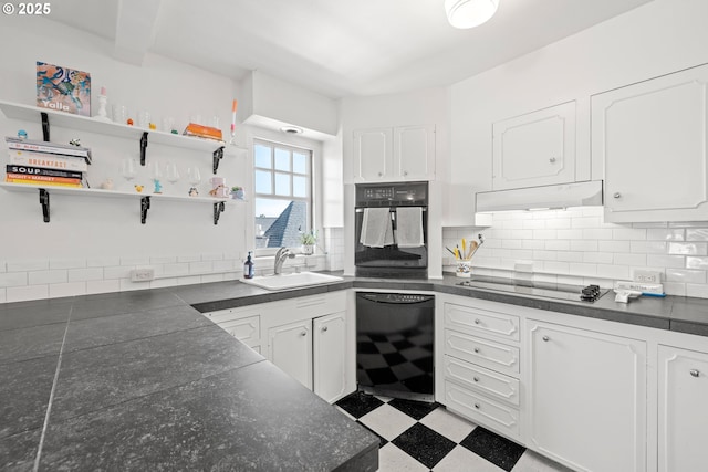 kitchen with decorative backsplash, sink, white cabinets, and black appliances