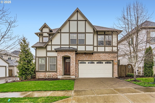 tudor home with stucco siding, roof with shingles, concrete driveway, an attached garage, and brick siding