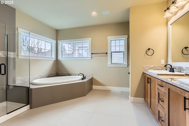 bathroom featuring a shower stall, decorative backsplash, baseboards, a bath, and vanity