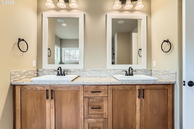 full bathroom featuring a sink, tasteful backsplash, and double vanity