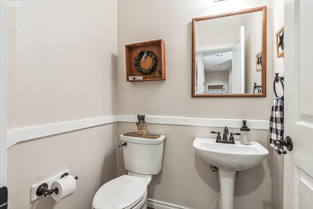 half bathroom featuring toilet