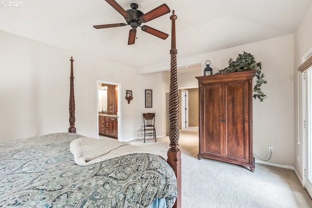 bedroom featuring baseboards, light colored carpet, ceiling fan, and ensuite bath
