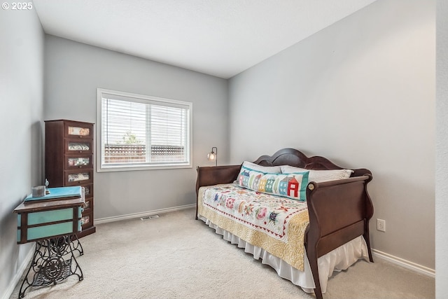 carpeted bedroom with baseboards and visible vents