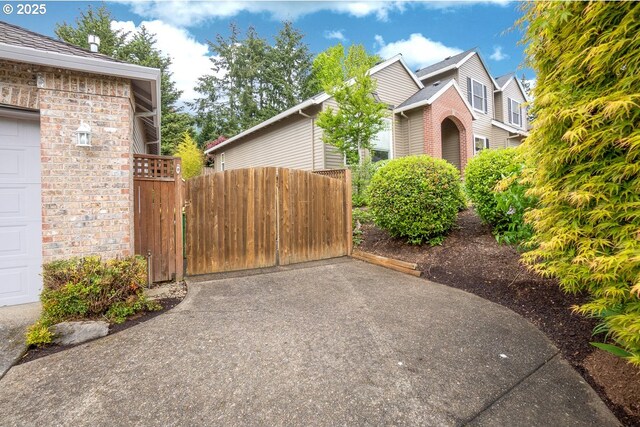 view of property exterior featuring fence and a garage